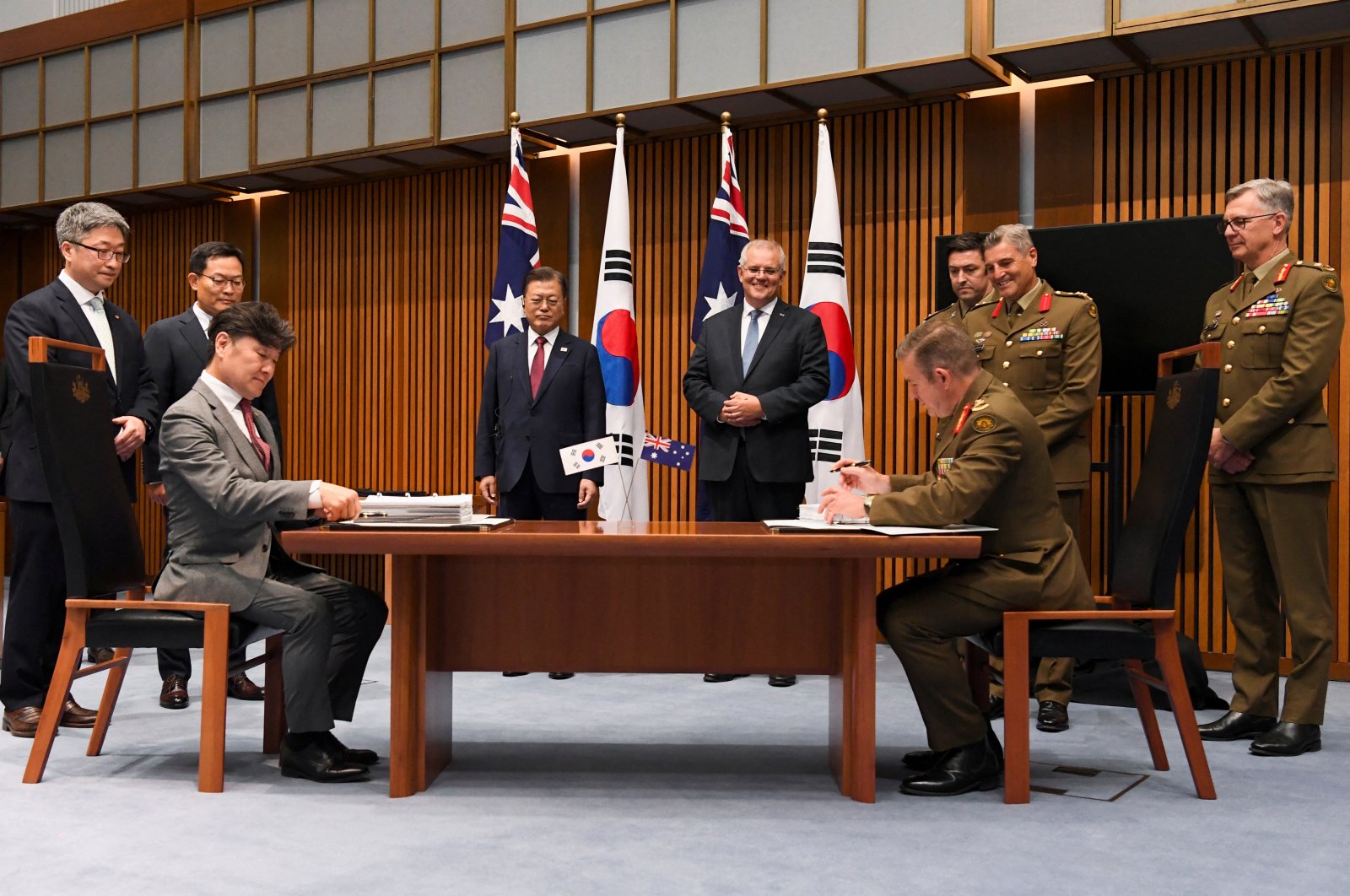 Australian Prime Minister Scott Morrison and South Korean President Moon Jae-in witness representatives of Hanwha Group and members of the Australian Defence Force during a signing ceremony at Parliament House, in Canberra, Australia, Dec. 13, 2021. (Reuters Photo)