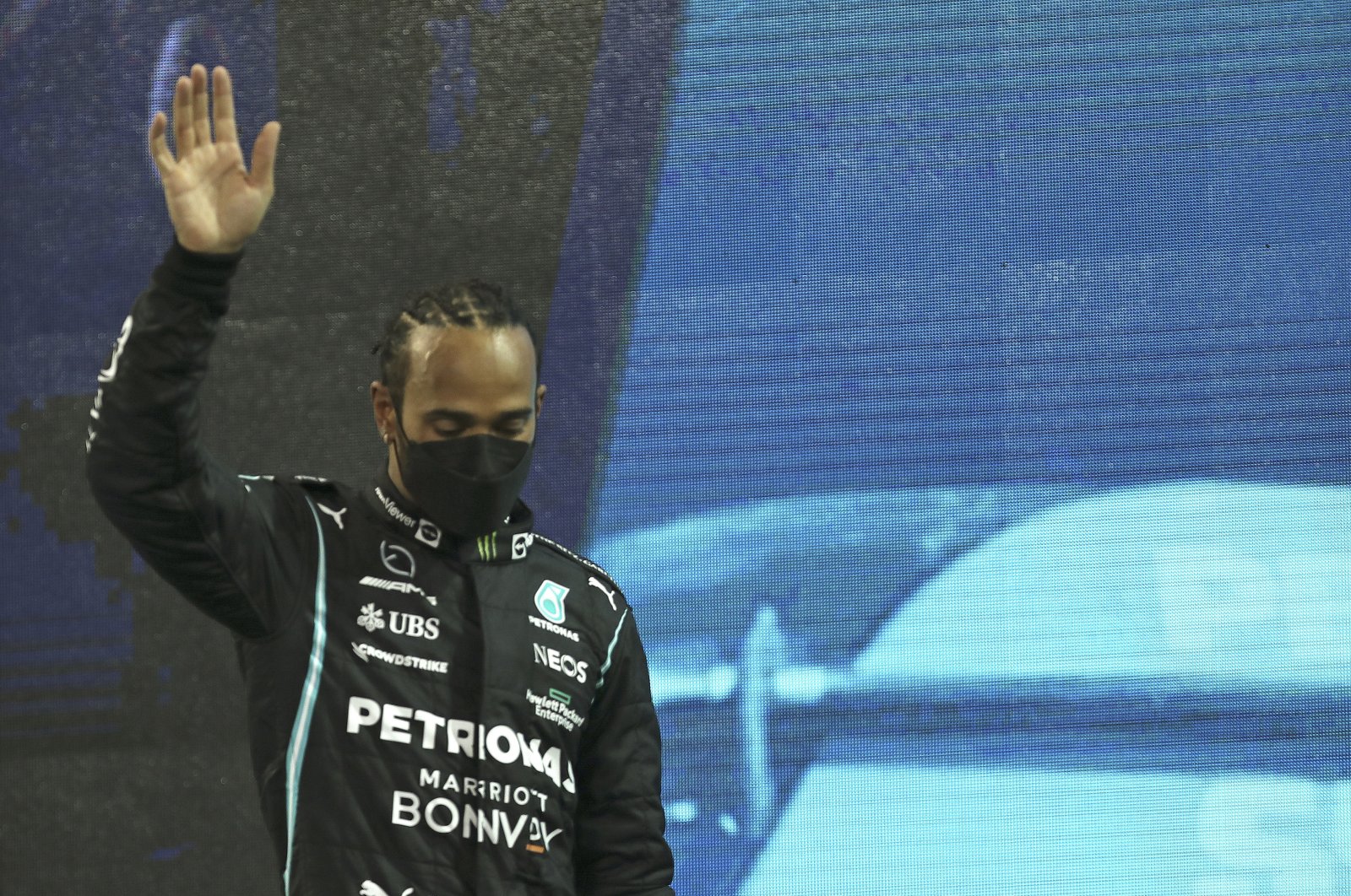 Mercedes driver Lewis Hamilton looks down as he walks onto the podium after finishing second in the F1 Abu Dhabi GP in Abu Dhabi, UAE, Dec. 12. 2021. (AP Photo)