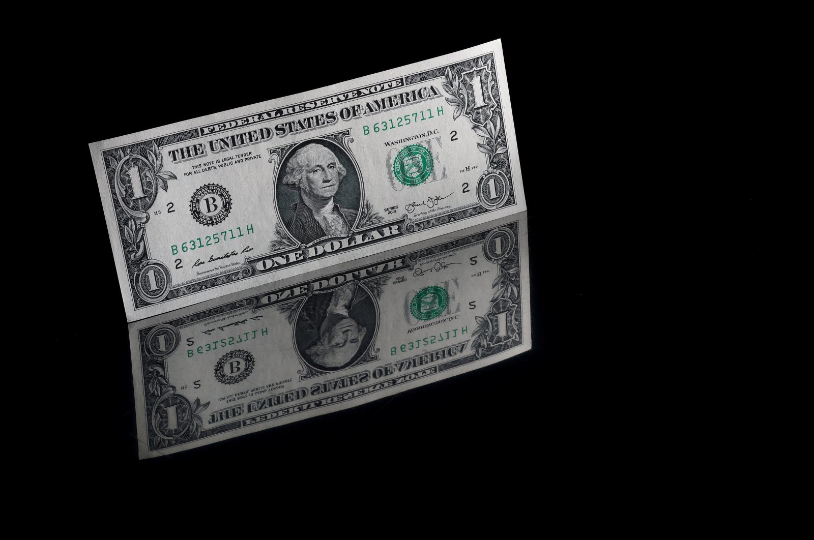 An illustration of one U.S. dollar banknote, Nov. 23, 2021. (Murad Sezer via Reuters)