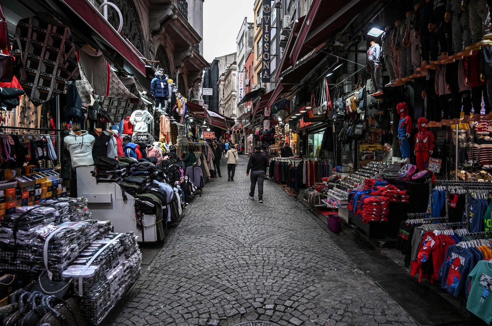 Pedestrians walk in Mahmutpasa district, one of Istanbul&#039;s biggest textile shopping centers, near Grand Bazaar, Istanbul, Turkey, Nov. 24, 2021. (AFP Photo)