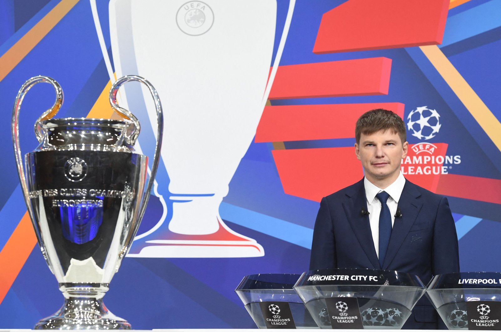 Former Russian forward Andrey Arshavin poses by the trophy during the Champions League Round of 16 draw at the UEFA headquarters in Nyon, Switzerland, Dec. 13, 2021. (AFP Photo)