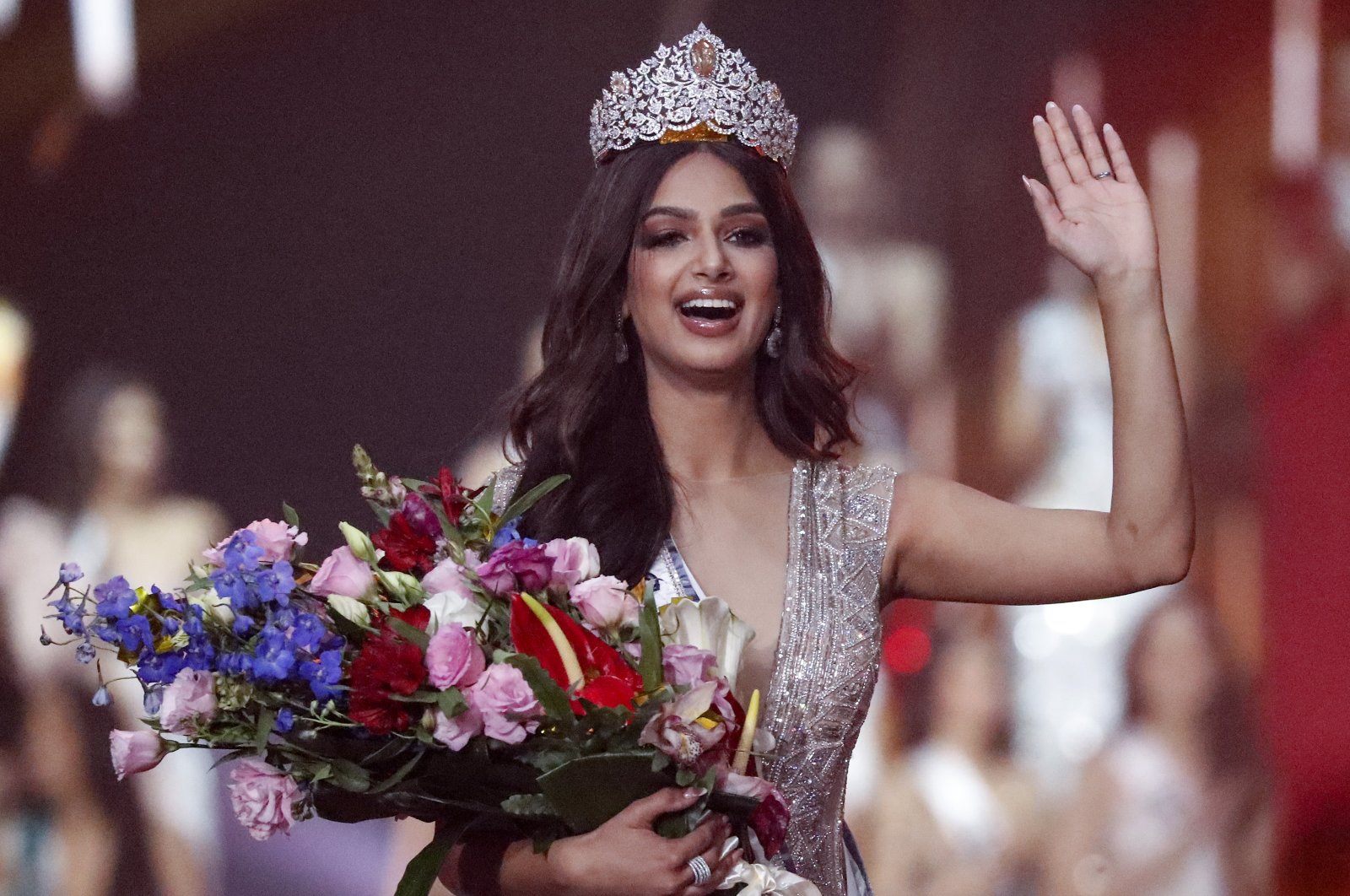 India&#039;s Harnaaz Sandhu waves after being crowned Miss Universe 2021 during the 70th Miss Universe pageant, Eilat, Israel, Dec. 13, 2021. (AP Photo)
