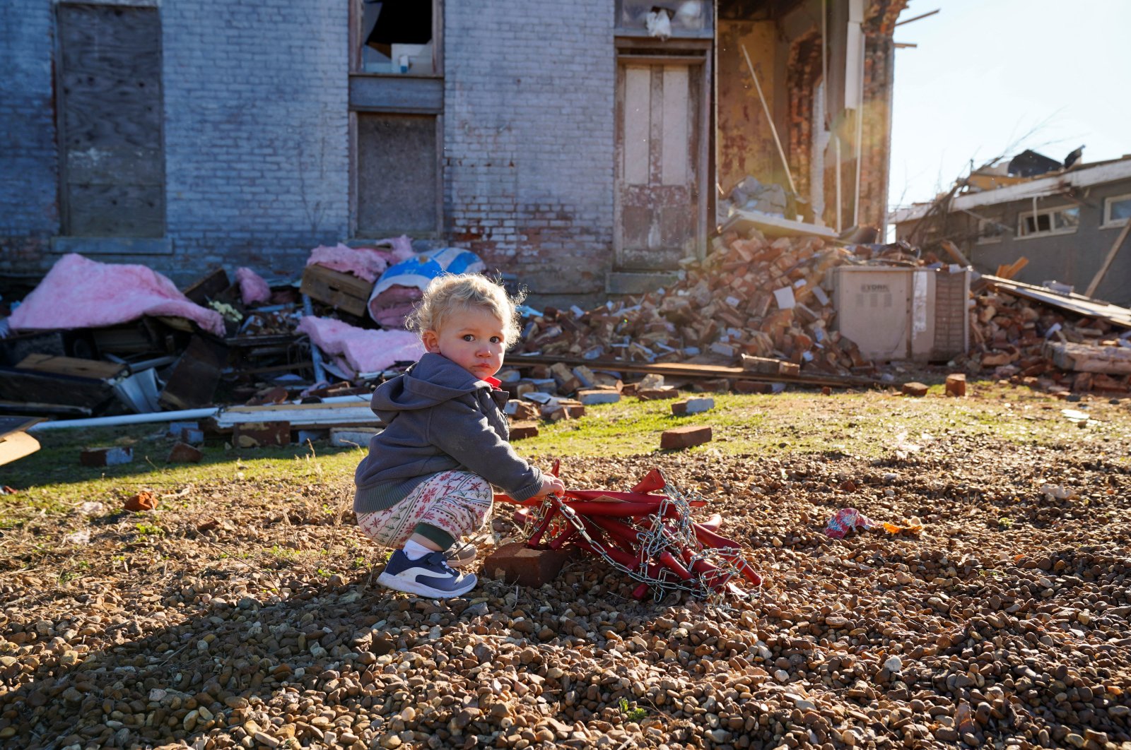 Gus Hart, 1, plays outside the home the Hart family had been renovating, with plans to move into, after a devastating outbreak of tornadoes ripped through several U.S. states in Mayfield, Kentucky, U.S., Dec. 12, 2021. (Reuters Photo)