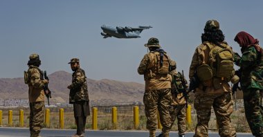 A C-17 Globemaster takes off as Taliban fighters secure the outer perimeter, alongside the U.S.-controlled side of Kabul Hamid Karzai International Airport, Kabul, Afghanistan, Aug. 29, 2021. (Photo by Getty Images)