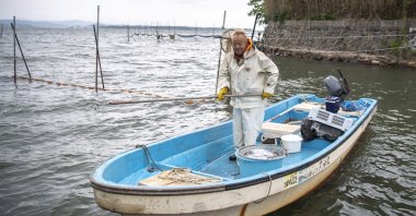 An eel fisherman Kunihiko Kato checks his nets in Hamamatsu, Shizuoka prefecture, Japan, April 16, 2021. (AFP Photo)