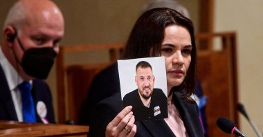 Belarusian opposition leader Svetlana Tikhanovskaya (R) holds a picture of her husband, the jailed opposition figure and blogger Sergei Tikhanovsky, during her speech at the Senate of the Parliament of the Czech Republic in Prague, Czech Republic, June 9, 2021. (AFP Photo)