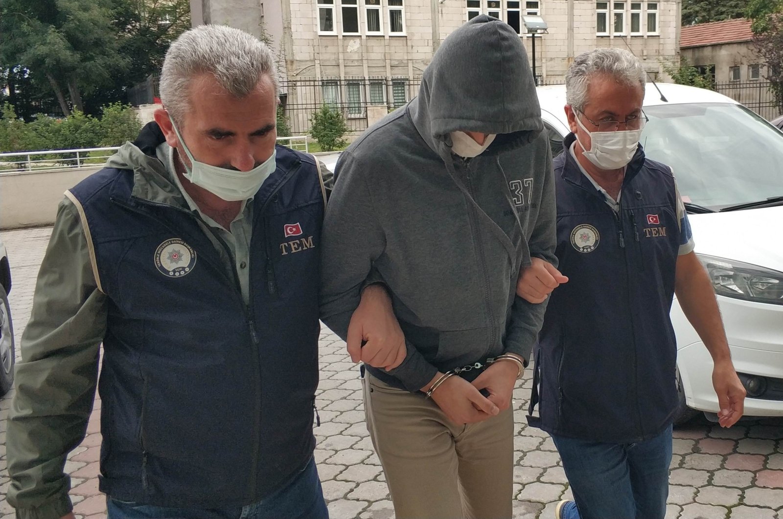 Police officers accompany a captured FETÖ suspect, in Denizli, western Turkey, Dec. 13, 2021. (İHA PHOTO) 