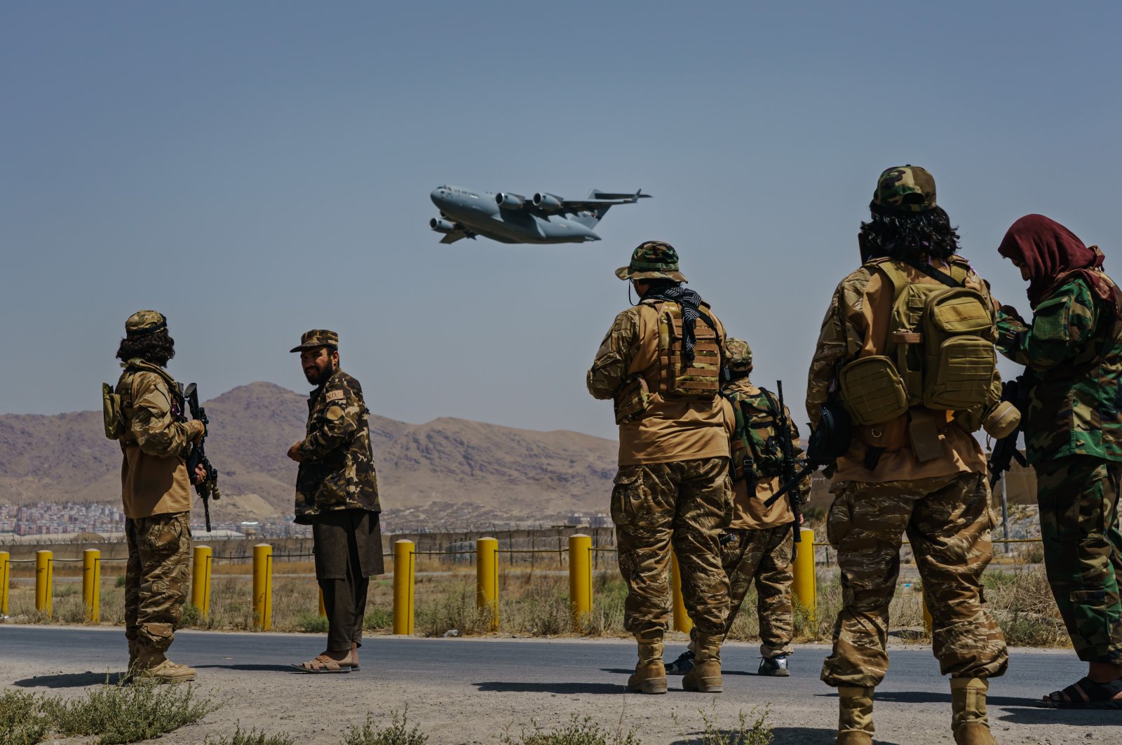 A C-17 Globemaster takes off as Taliban fighters secure the outer perimeter, alongside the U.S.-controlled side of Kabul Hamid Karzai International Airport, Kabul, Afghanistan, Aug. 29, 2021. (Photo by Getty Images)