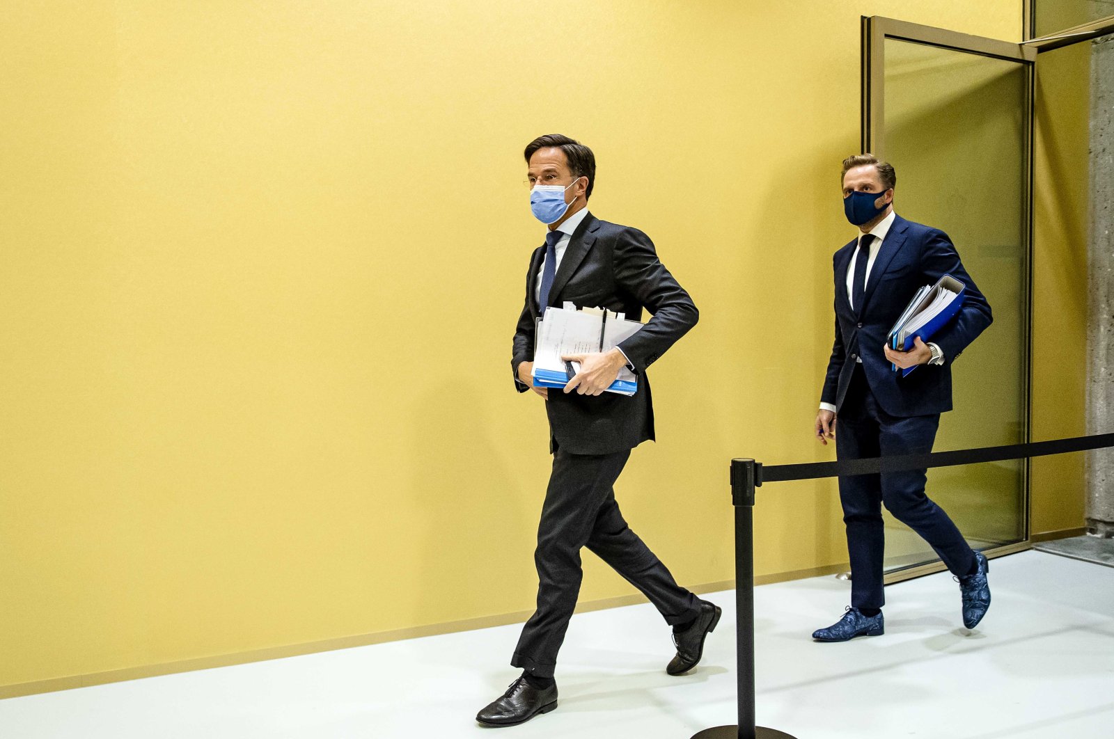 Outgoing Prime Minister Mark Rutte (L) and Hugo de Jonge, outgoing Minister for Public Health, Welfare and Sport (R) walk during a suspension of the debate about the developments surrounding the coronavirus in the House of Representatives in The Hague, Netherlands, Dec. 1, 2021. (EPA Photo)