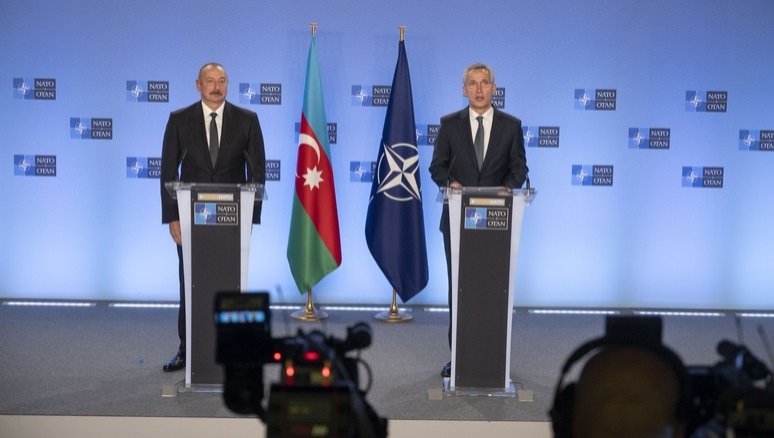 Azerbaijani President Ilham Aliyev (L) speaks at a joint news conference with NATO Secretary-General Jens Stoltenberg in Brussels, Belgium, Tuesday, Dec. 14, 2021. (IHA Photo)