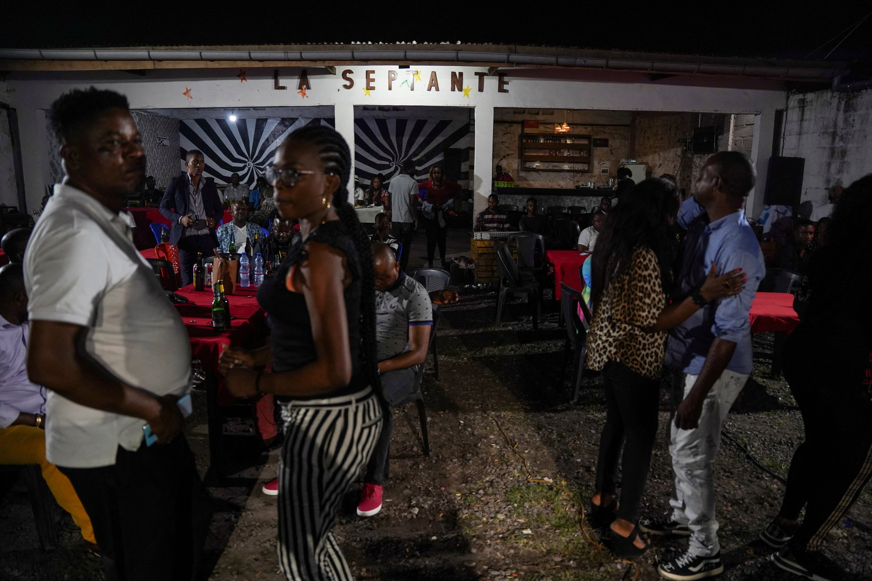 People dance to Congolese rumba played by the Bana OK band at La Septante club in the Kasa-Vubu quarter of Kinshasa, Democratic Republic of the Congo, Sept. 24, 2021. (REUTERS)