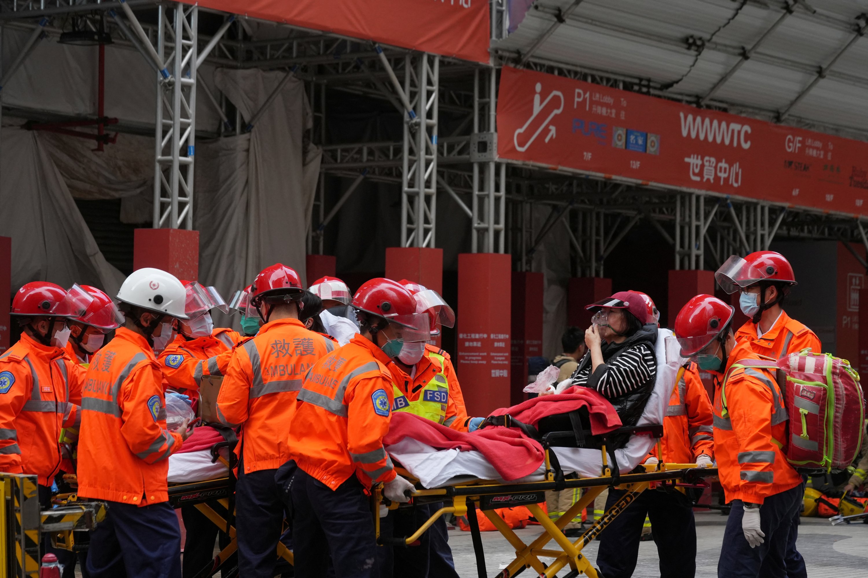 Rescue workers carry a survivor on a stretcher after a fire broke out at the World Trade Center in Hong Kong, China, Dec. 15, 2021. (Reuters Photo)