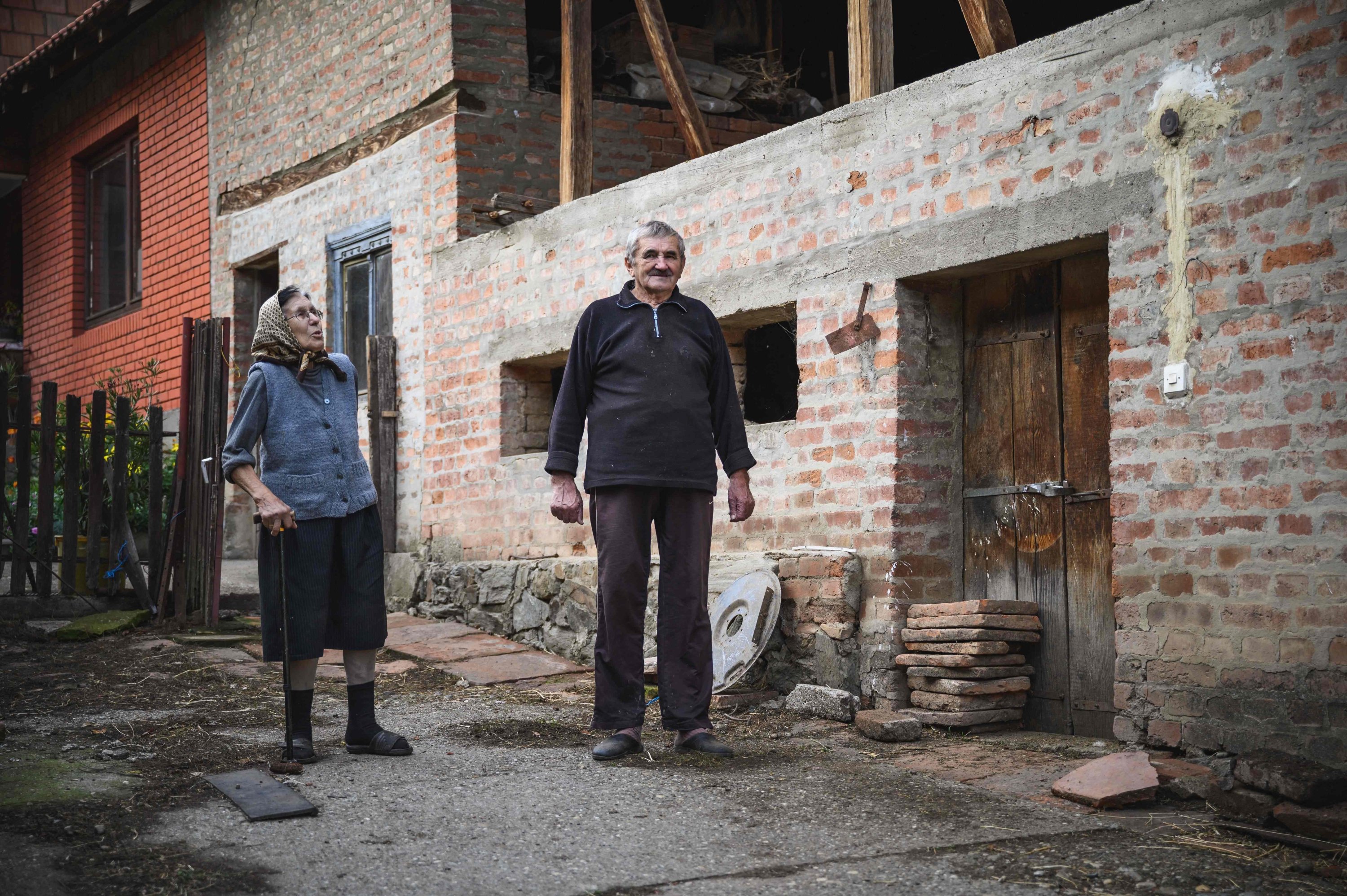 Jezda Ivanovic and his wife Verica stand in their yard next to a small pile of Roman bricks, in central Serbia's Stari Kostolac on Dec. 3, 2021. (AFP Photo)