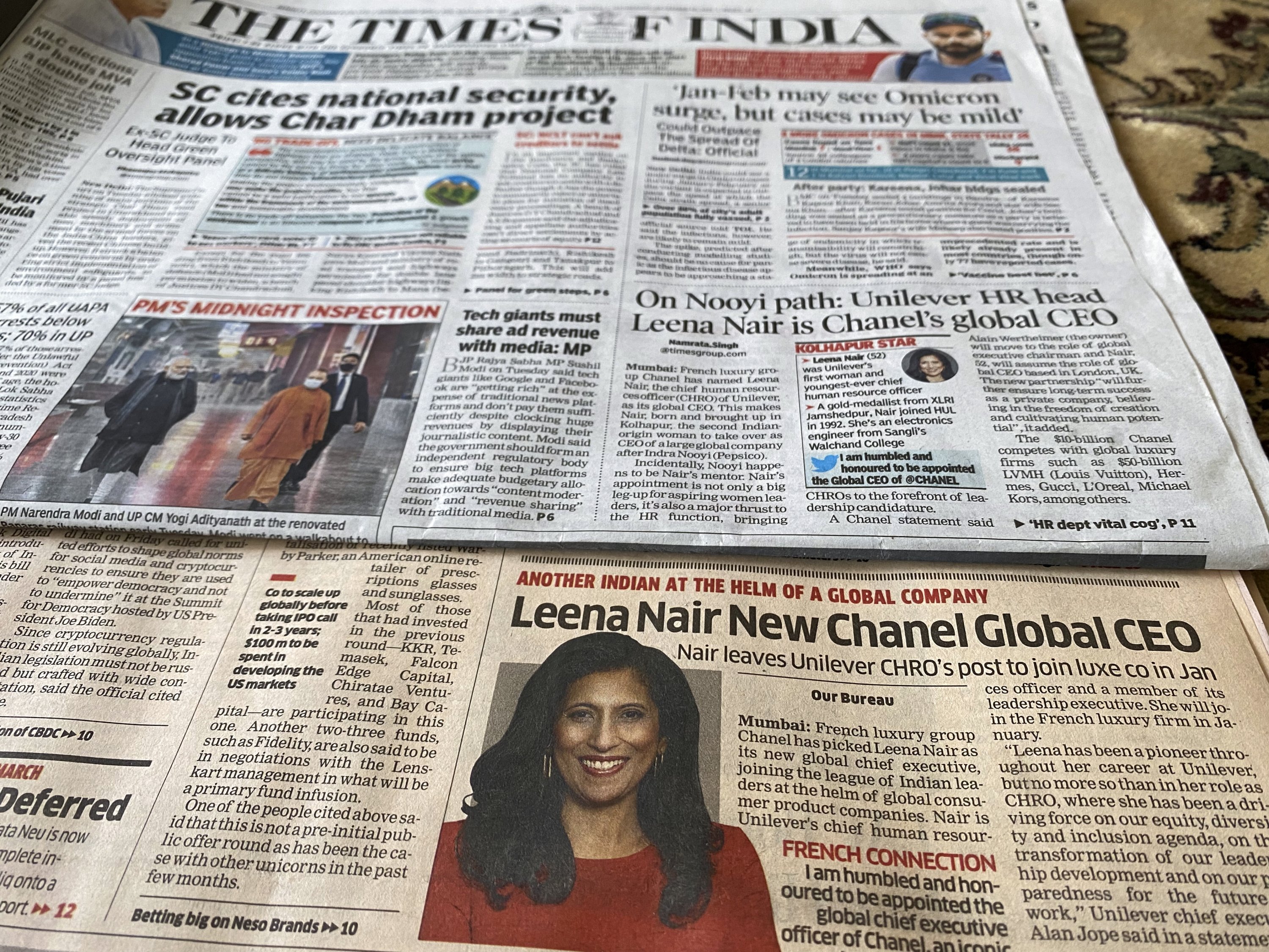 Two Indian newspapers report the news of Unilever executive Leena Nair being chosen as the new CEO of luxury fashion house Chanel on their front page in Mumbai, India, Dec. 15, 2021. (AP Photo)