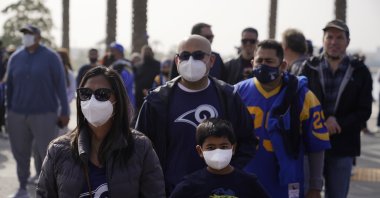 Fans wear masks amid the COVID-19 pandemic as they enter a stadium before an NFL game between the Los Angeles Rams and the Jacksonville Jaguars, California, U.S., Dec. 5, 2021. (AP Photo)