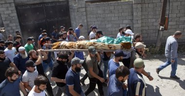 People carry the body of Zelimkhan Khangoshvili, a Georgian Muslim, during his funeral in Duisi village, the Pankisi Gorge valley, Georgia, Aug. 29, 2019. (AP Photo)
