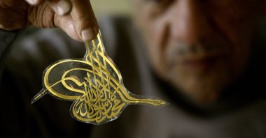 Lebanese Arabic-language calligrapher Salah Al-Hafi showing his work at his workshop in Beirut, Lebanon, Jan. 11, 2011. (AFP)