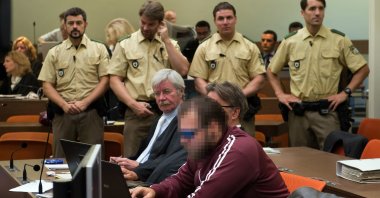 Andre E. and his lawyers wait for the start of hearing at a courthouse in Munich, Germany, Aug. 6, 2013. (GETTY IMAGES) 