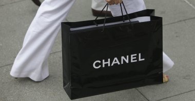 A woman carries a bag from Chanel while walking through Union Square in San Francisco, July 28, 2009. (AP Photo)