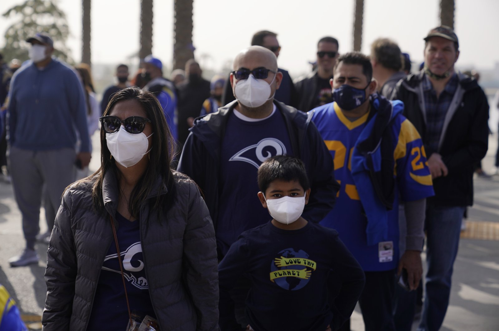 Fans wear masks amid the COVID-19 pandemic as they enter a stadium before an NFL game between the Los Angeles Rams and the Jacksonville Jaguars, California, U.S., Dec. 5, 2021. (AP Photo)