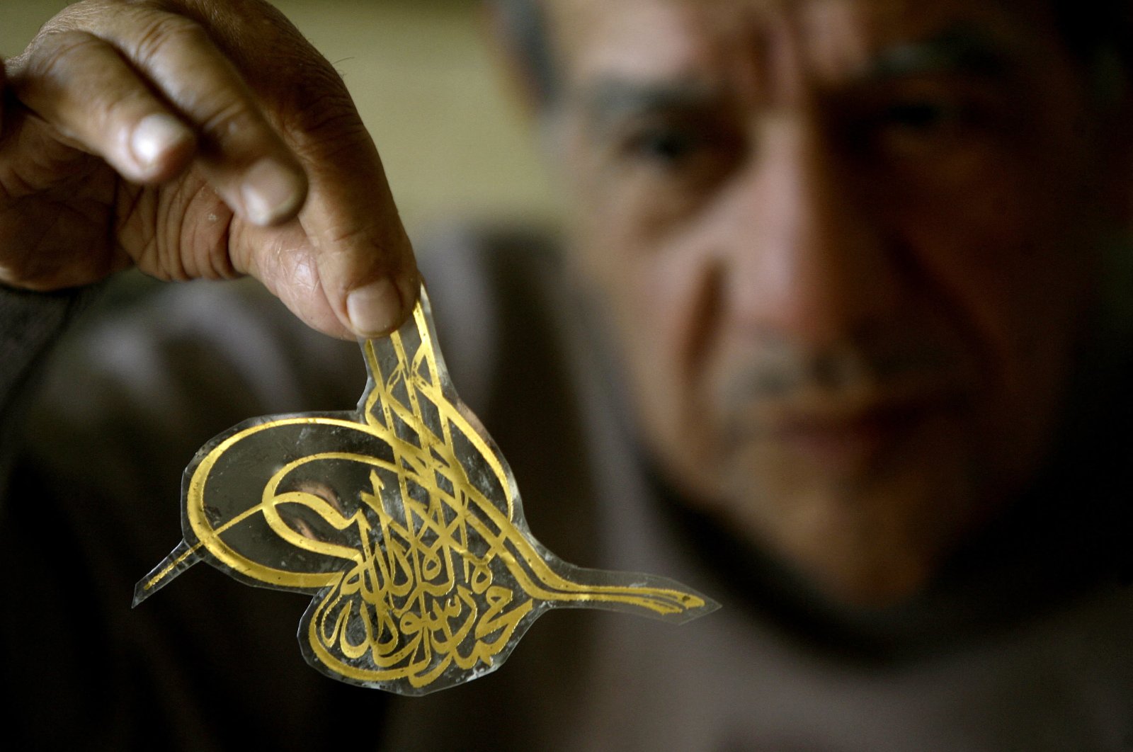 Lebanese Arabic-language calligrapher Salah Al-Hafi showing his work at his workshop in Beirut, Lebanon, Jan. 11, 2011. (AFP)