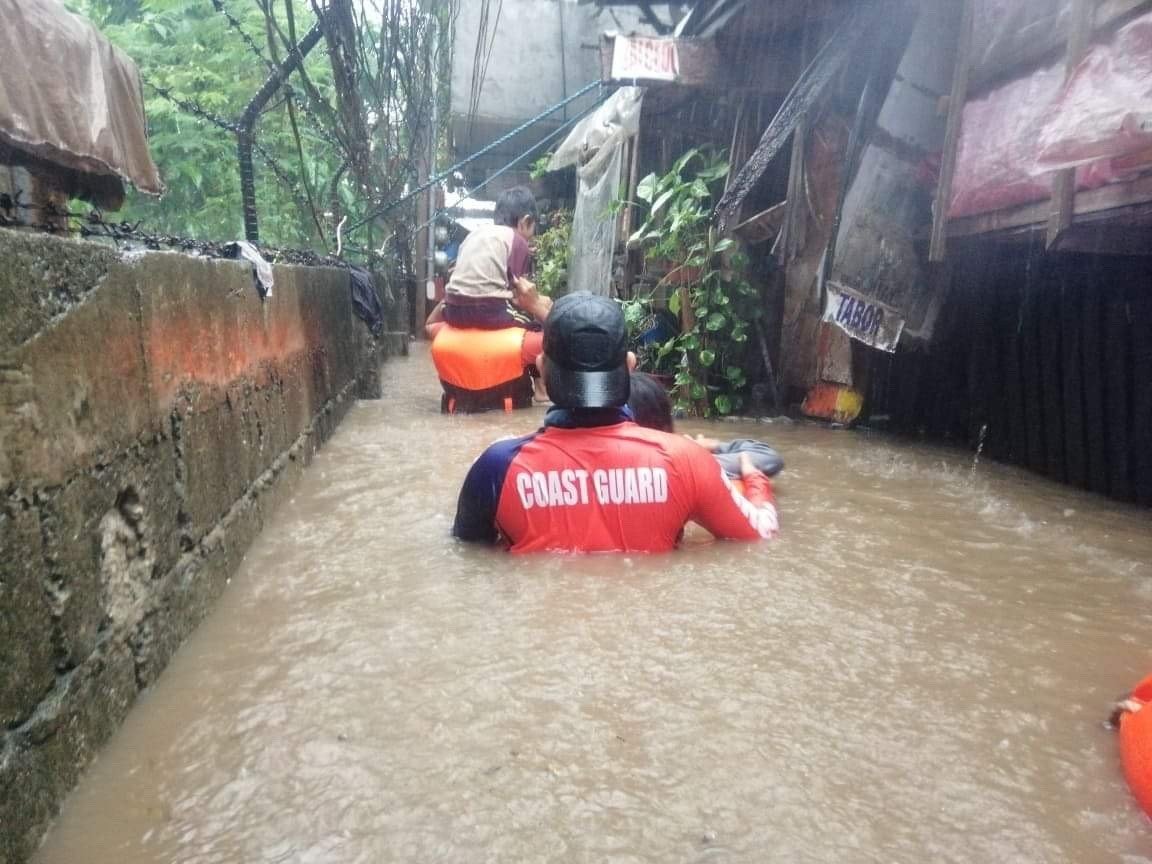 Philippine coast guard personnel conducting a rescue operation in the aftermath of a flood in the typhoon-hit city of Cagayan de Oro, southern Philippines, Dec. 16, 2021. (Philippine Coast Guard handout photo via EPA-EFE Photo)