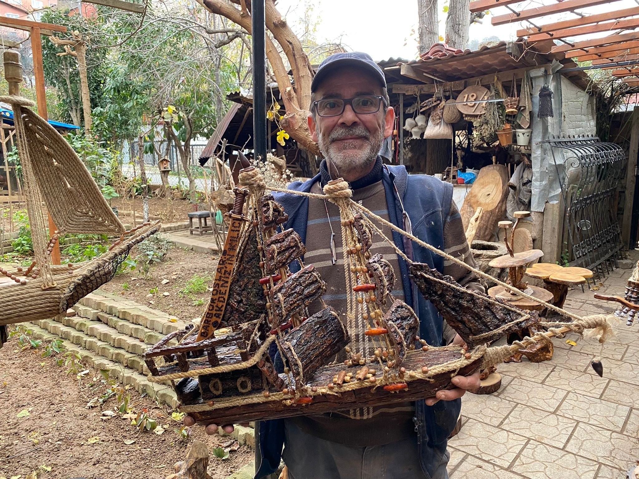 Mustafa Avcı holds one of his artworks made from rotten trees, Istanbul, Turkey, Dec. 12, 2021. (IHA Photo)