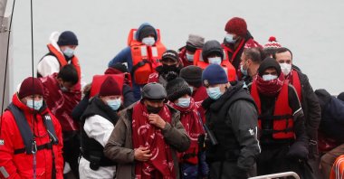 Migrants who arrived onboard a Border Force rescue boat are escorted by Border Force staff after having crossed the channel, at Dover harbor in Dover, Britain, Dec. 15, 2021. (Reuters Photo)