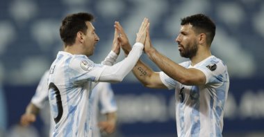 Argentina's Lionel Messi (L) celebrates scoring a goal with teammate Sergio Aguero during a Copa America match against Bolivia at Arena Pantanal, Cuiaba, Brazil, June 28, 2021. (AP Photo)