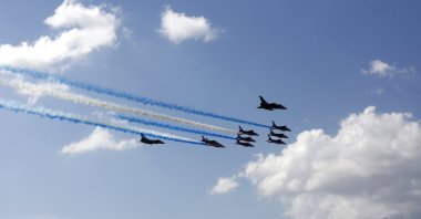 Two French Rafale fighter aircraft and the "Patrouille de France" aerobatic display team fly above Acropolis Hill, in Athens, Greece, Sept. 6, 2021. (EPA Photo)