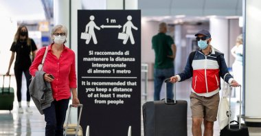 Passengers wearing protective face masks walk at Fiumicino Airport, in Rome, Italy, June 30, 2020. (REUTERS Photo)