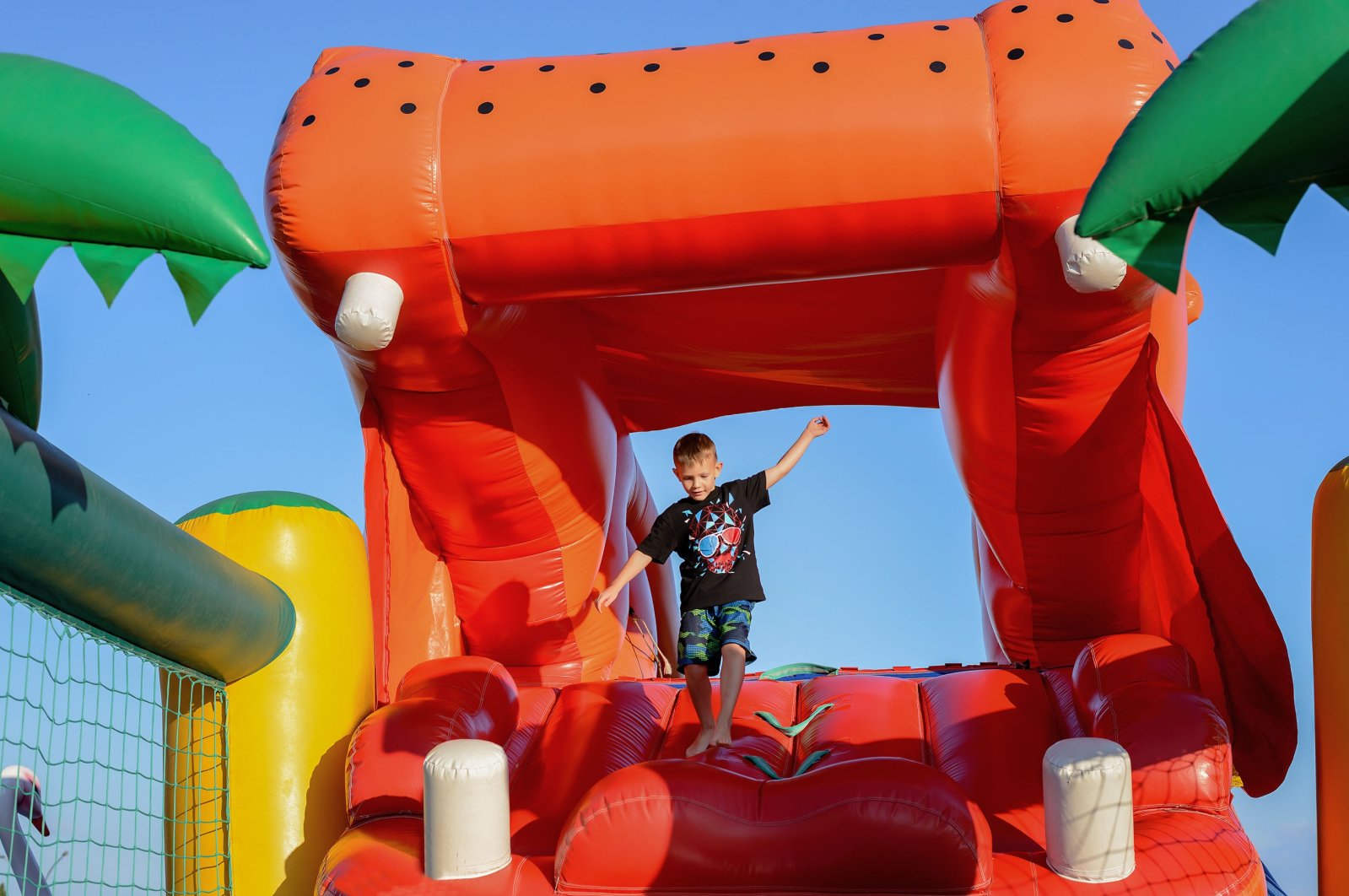 Young Boy Jumping on Bouncy Castle. (Shutterstock Photo) 