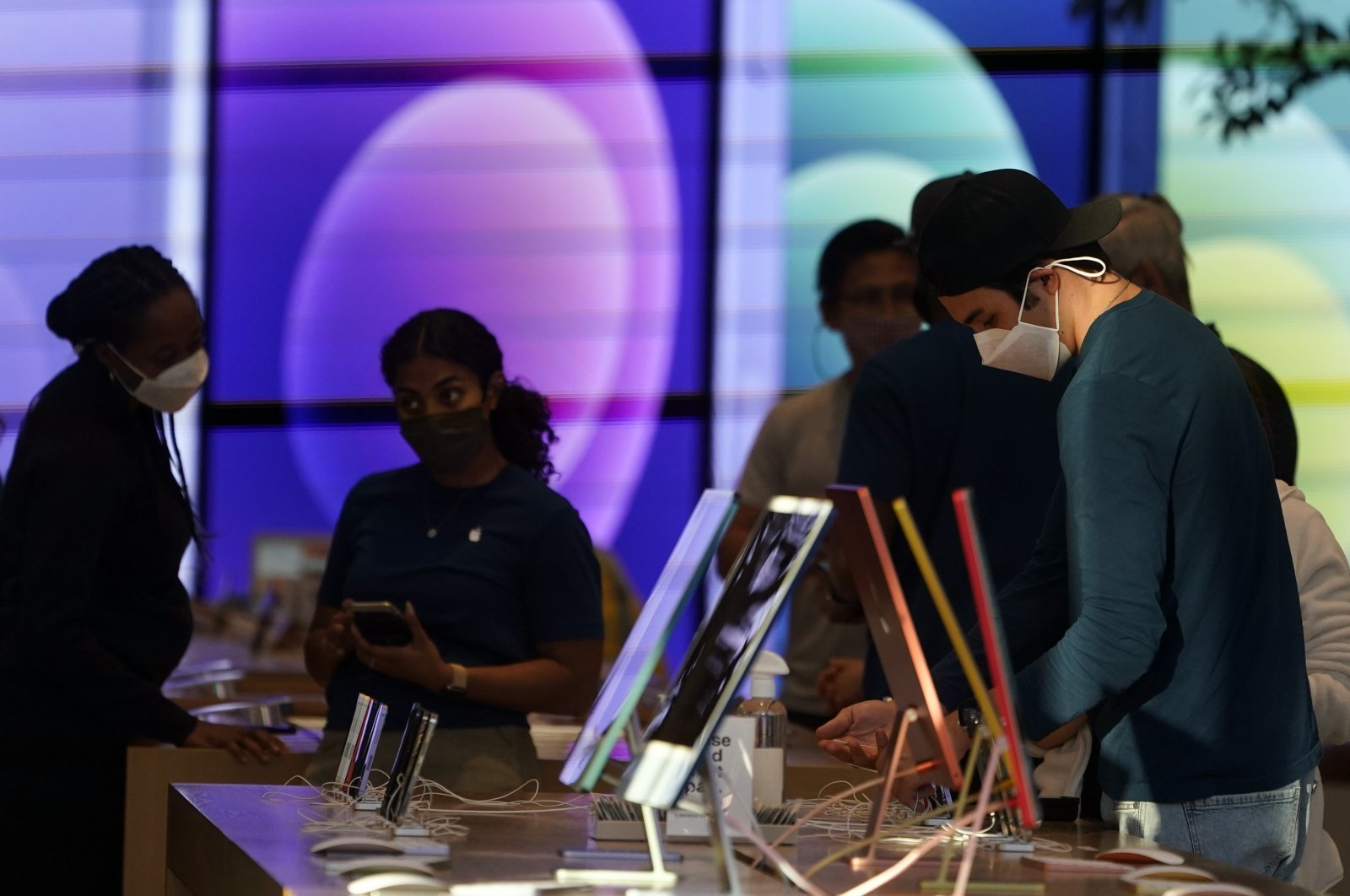 Workers and customers wear masks inside an Apple Store amid the COVID-19 pandemic on The Promenade, in Santa Monica, California, U.S., June 9, 2021. (AP Photo)