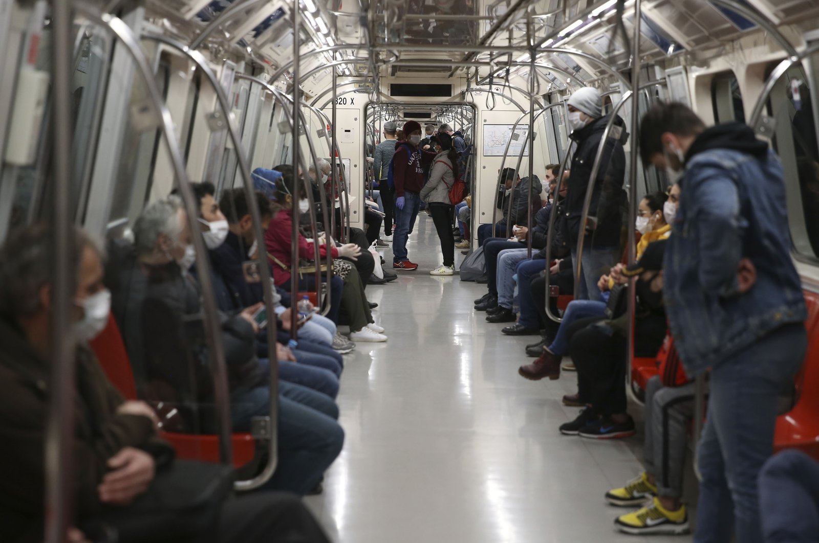 Commuters, most wearing protective masks due to the coronavirus outbreak, travel on the metro in Istanbul, Turkey, April 10, 2020. (AP Photo)