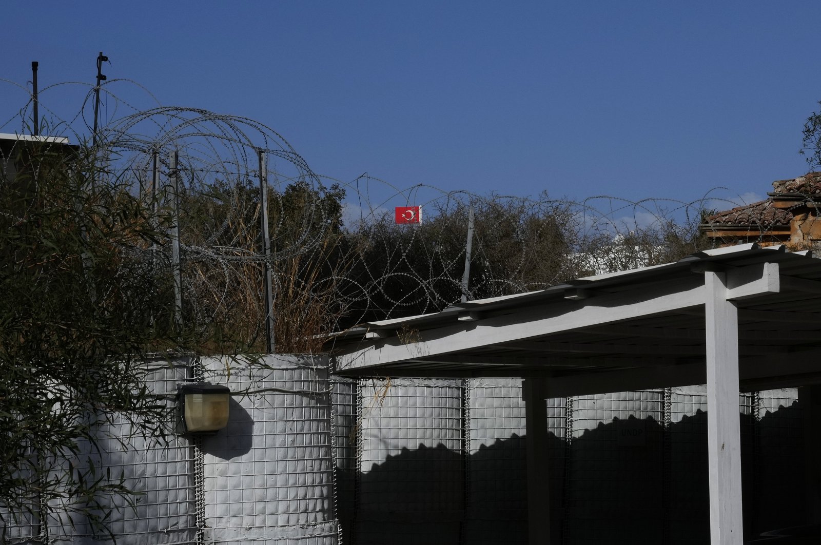A Turkish flag waves in the Turkish-controlled area in the U.N buffer zone between Turkish Cyprus and the Greek Cypriot administration in the divided capital Nicosia, Cyprus island, Dec. 1, 2021. (AP Photo)