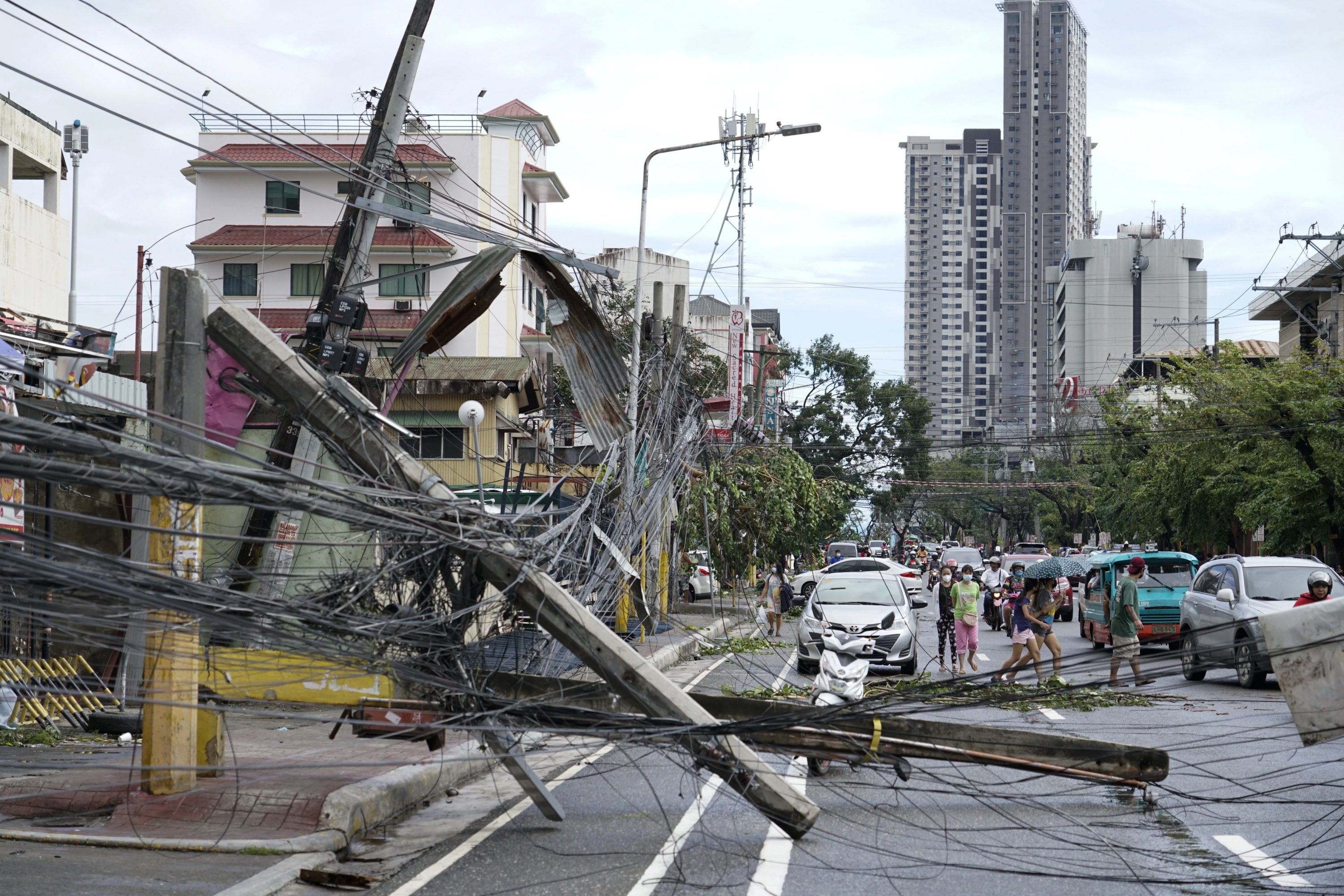 Toppled electrical posts lie along a street after Typhoon Rai hit in Cebu, central Philippines, Dec. 17, 2021. (AP Photo)