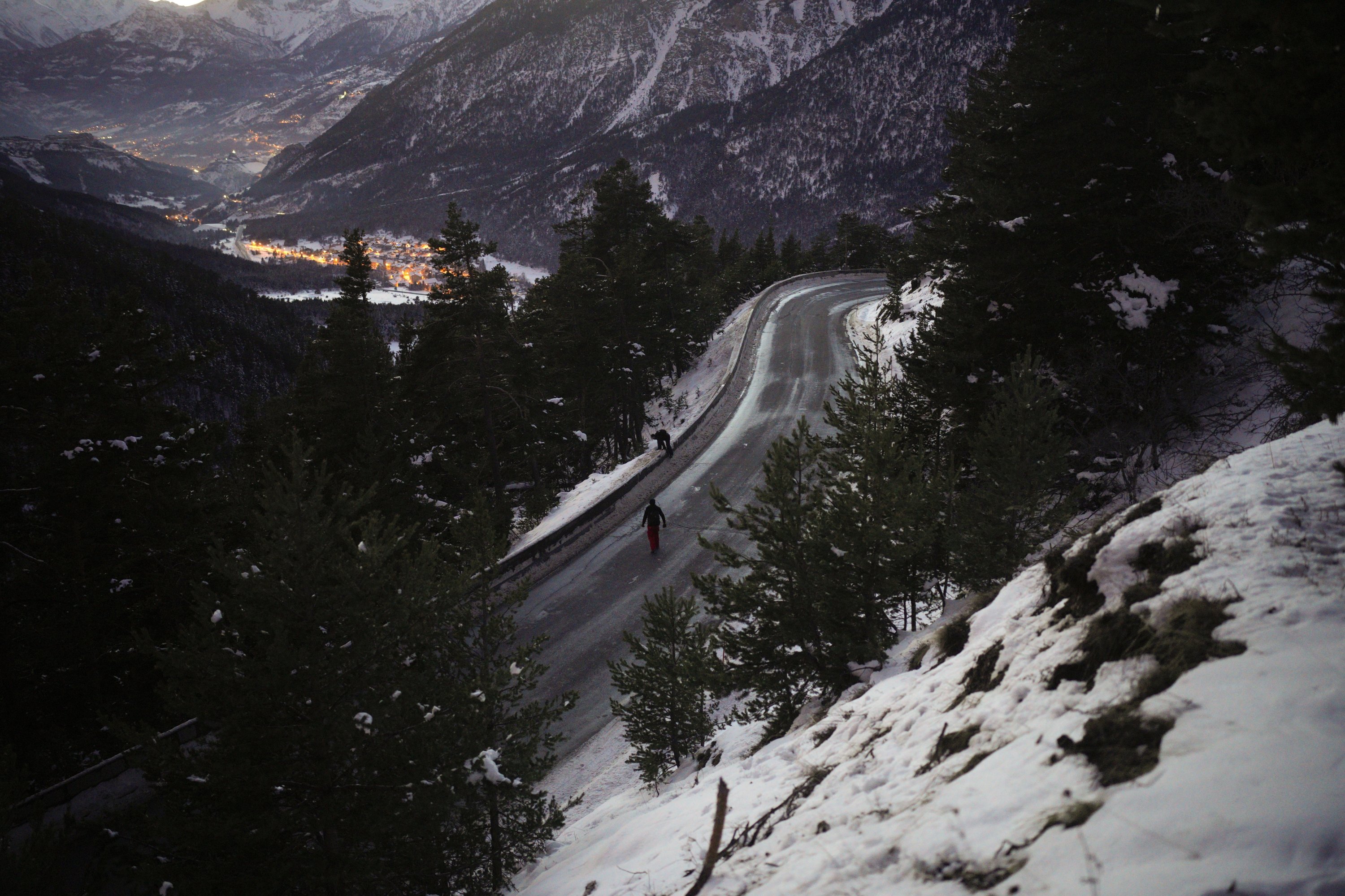 Afghan migrants Ali Rezaie and Sayed Hamza cross a mountain road in the French-Italian Alps to reach a migrant refuge in Briancon, France, Dec. 12, 2021.  (AP Photo)