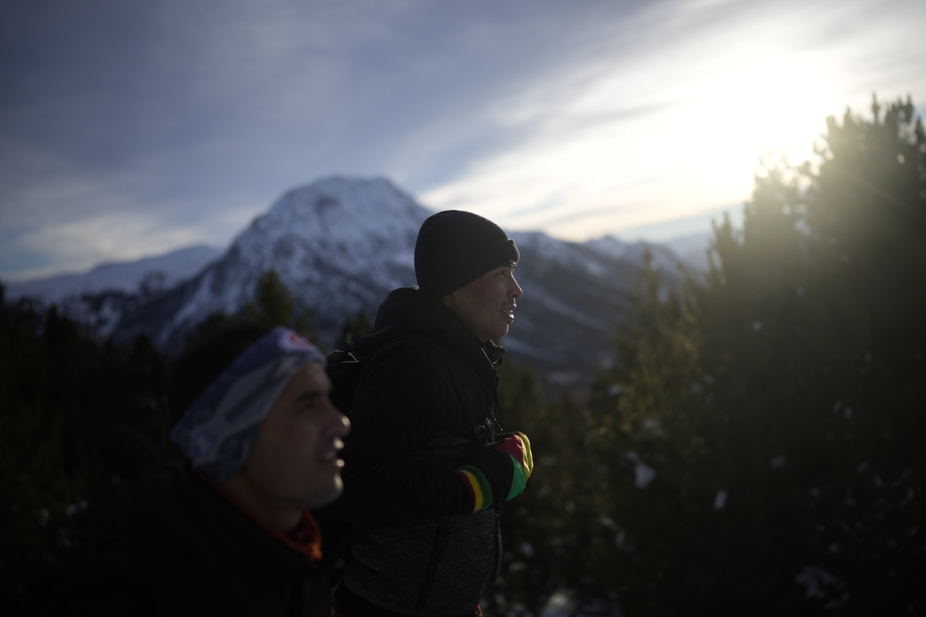 Afghan migrants Ali Rezaie (C) and Sayed Hamza trek through the French-Italian Alps to reach a migrant refuge in Briancon, France, Dec. 12, 2021. (AP Photo)