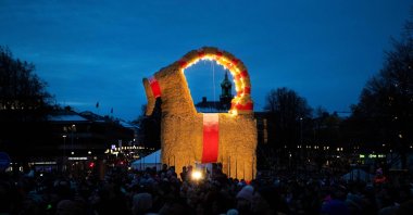 People gather at the inauguration of the traditional Christmas goat in Gavle, Sweden, Nov. 28, 2021. (AFP Photo)