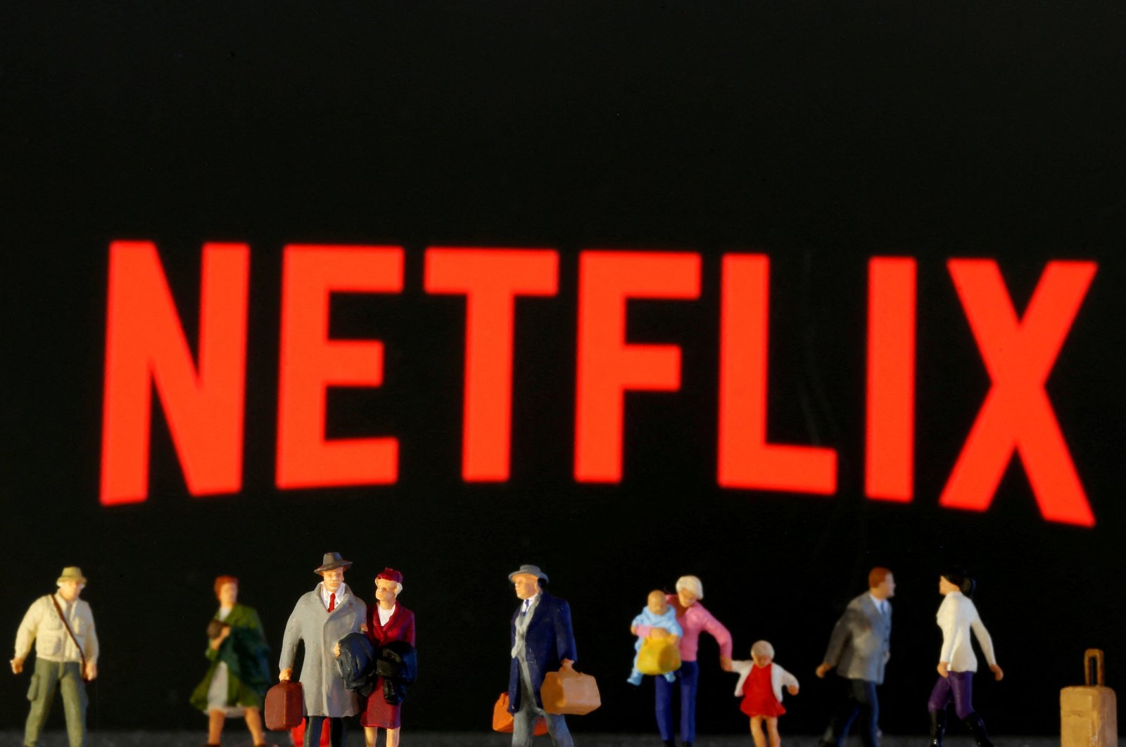 Small toy figures are seen in front of diplayed Netflix logo in this illustration, March 19, 2020. (Reuters Photo)