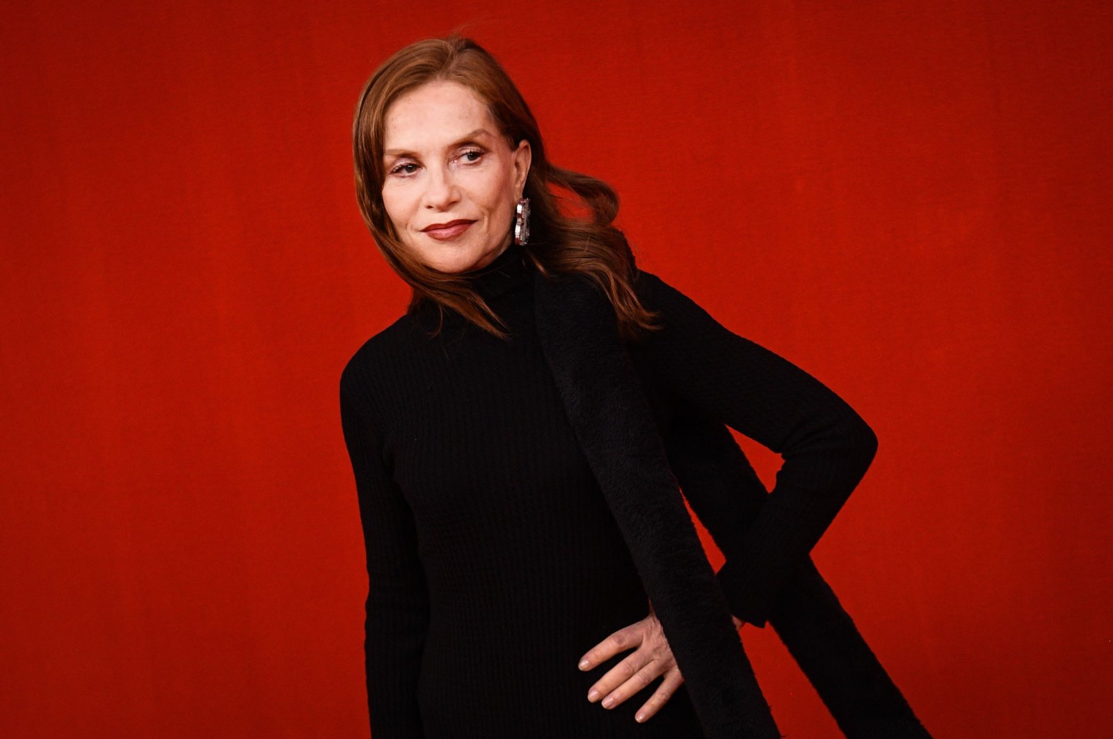 This file photo taken on Oct. 2, 2021, shows French actress Isabelle Huppert posing for photographs as she presents creations for Balenciaga during the Women&#039;s Spring-Summer 2022 Ready-to-Wear collection fashion show in Paris, as part of the Paris Fashion Week. (AFP)