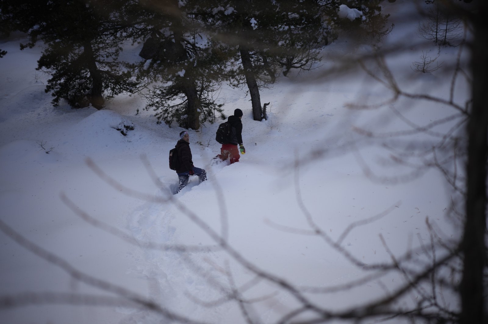 Afghan migrants Ali Rezaie (R) and Sayed Hamza trek through the French-Italian Alps to reach a migrant refuge in Briancon, France, Dec. 12, 2021. (AP Photo)