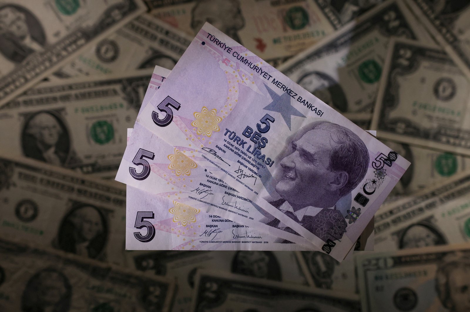 Turkish lira banknotes are seen placed on U.S. dollar banknotes in this illustration taken on Nov. 28, 2021. (Reuters Photo)