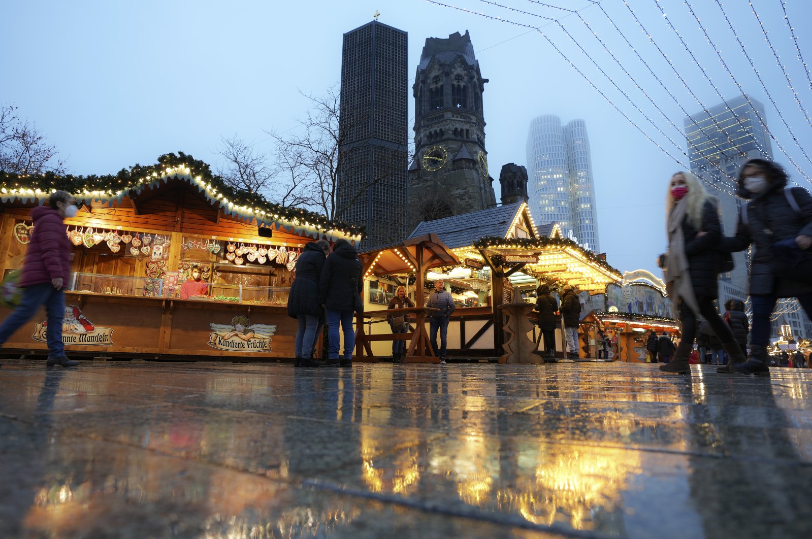 People visit the Christmas market at the Breitscheidplatz (Breitscheid Square) in Berlin, Germany, Dec. 13, 2021. (AP Photo)