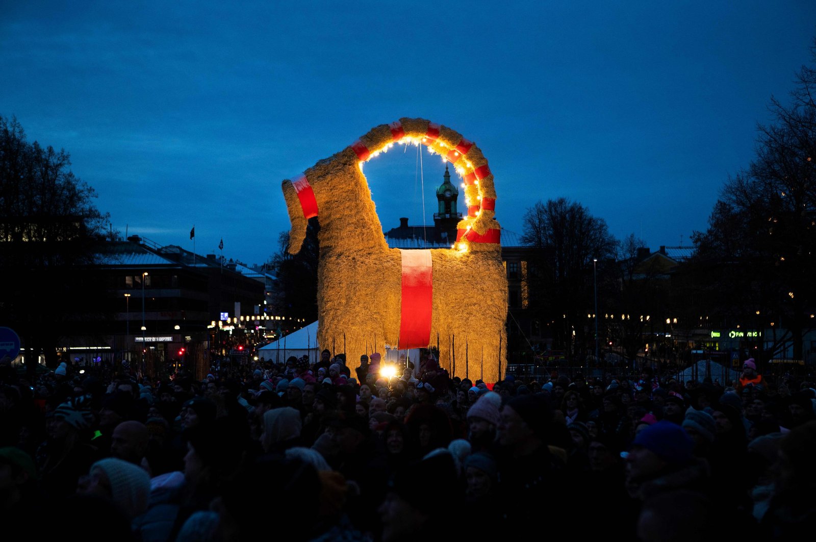 People gather at the inauguration of the traditional Christmas goat in Gavle, Sweden, Nov. 28, 2021. (AFP Photo)