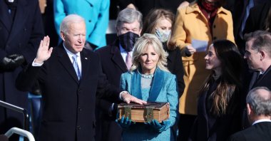 Joe Biden (L) stands with his wife Jill Biden (C) as he is given the oath of office by U.S. Supreme Court Chief Justice John Roberts during the presidential inauguration ceremony on the West Front of the U.S. Capitol in Washington, D.C., U.S., Jan. 20, 2021. (EPA Photo)