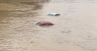 Partially submerged cars are seen on a flooded road in Shah Alam, Malaysia, Dec. 18, 2021. (Reuters)