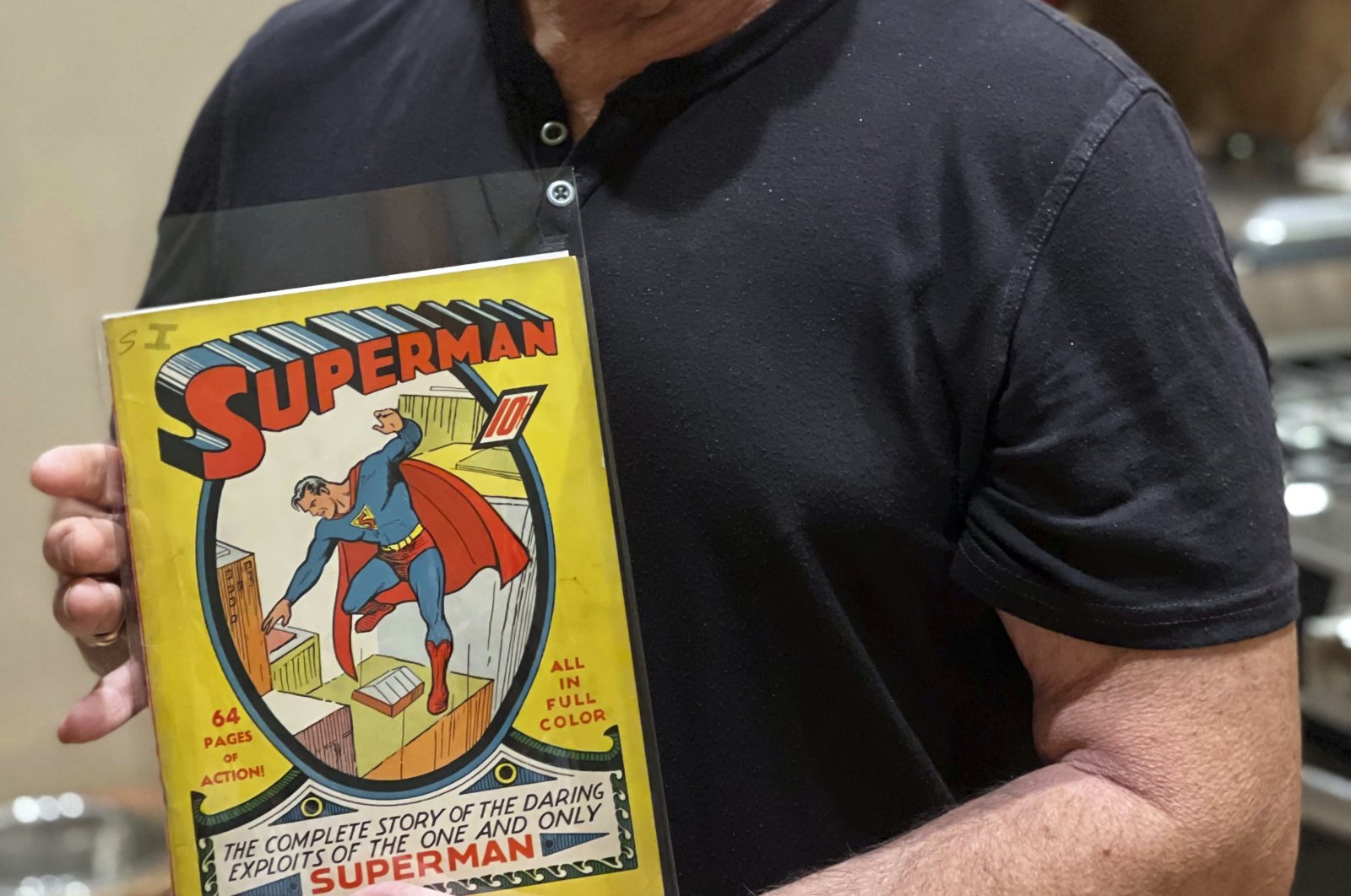 Mark Michaelson holds his rare copy of a Superman #1 comic book that sold on newsstands for a dime in 1939 in this undated photo. (Sara Michaelson/Mark Michaelson via AP)