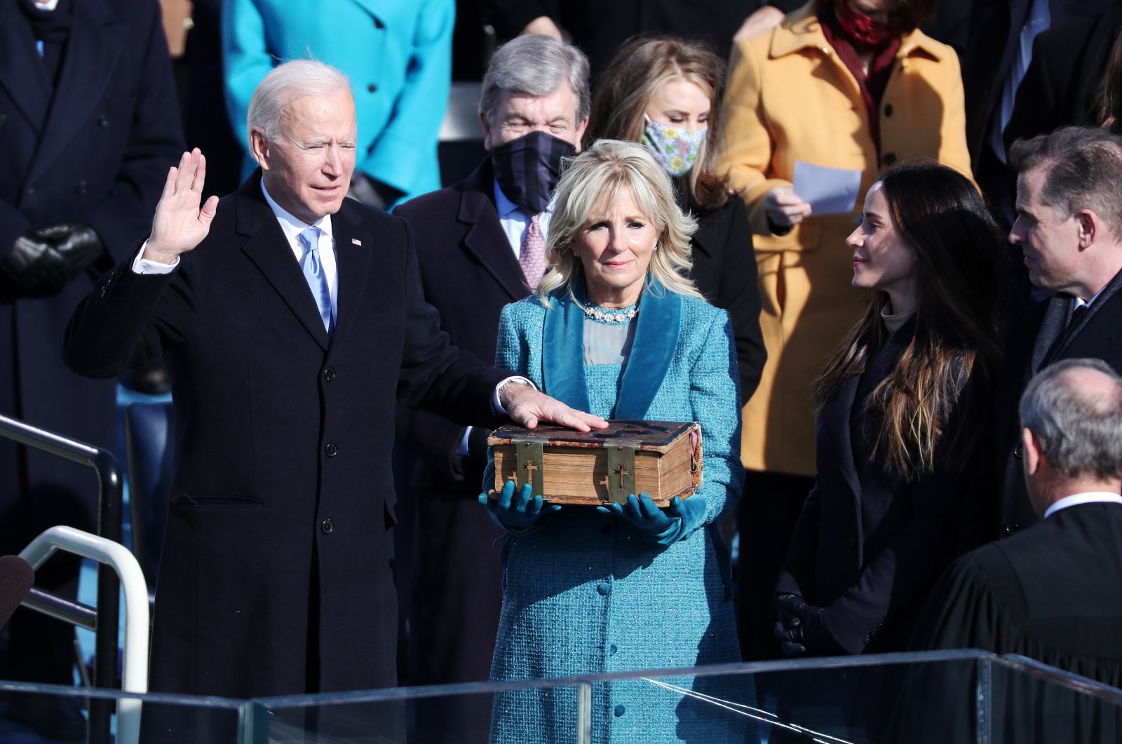Joe Biden (L) stands with his wife Jill Biden (C) as he is given the oath of office by U.S. Supreme Court Chief Justice John Roberts during the presidential inauguration ceremony on the West Front of the U.S. Capitol in Washington, D.C., U.S., Jan. 20, 2021. (EPA Photo)