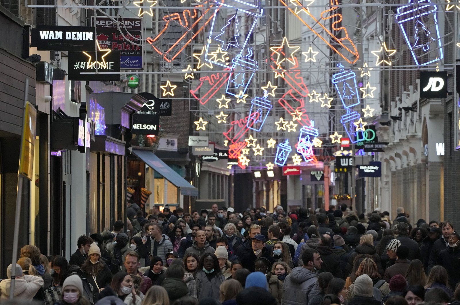 A bustling street on the last Saturday before Christmas in Amsterdam, the Netherlands, Dec. 18, 2021. (AP Photo)